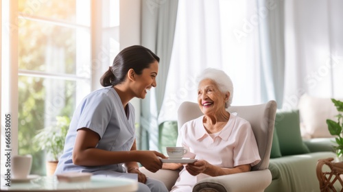 Healthcare, elderly woman with nurse with breakfast at her home and at the table in living room. Support or communication, caregiver and conversation with medical person with senior or old female.
