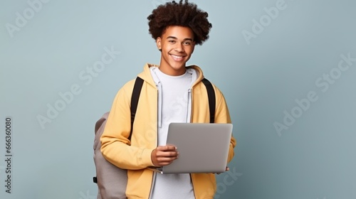 portrait of a male student with school bag studio background