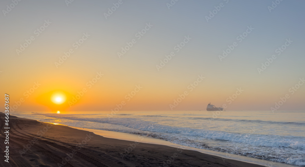 Beautiful sunrise over the black sand beach of Port of San Jose in Guatemala