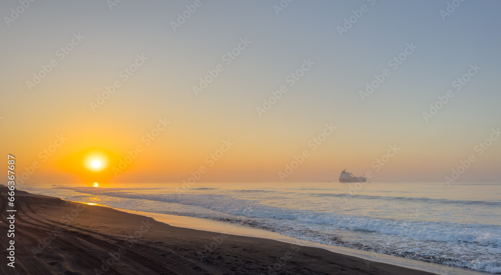 Beautiful sunrise over the black sand beach of Port of San Jose in Guatemala Beautiful sunrise over the black sand beach of Port of San Jose in Guatemala