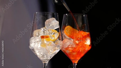 Apperol Spritz cocktail. 4k video while a bartender prepares two glasses of two Apperol Spritz drinks.