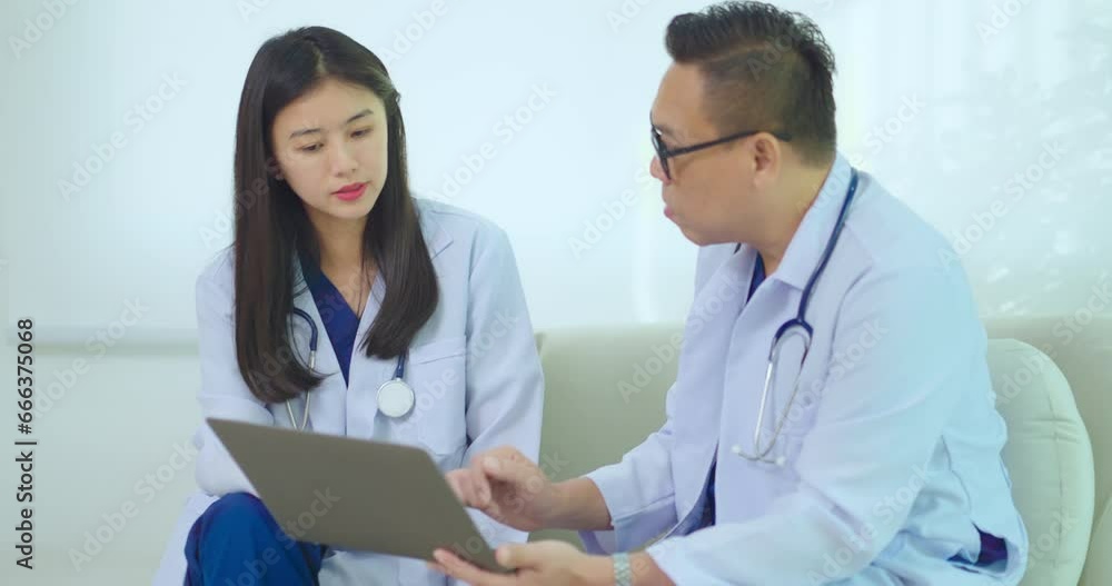 Two doctor talking together at hospital. They discussing about patient Illness together at hospital. Two doctor talking together at hospital. They discussing about patient Illness together at hospital.