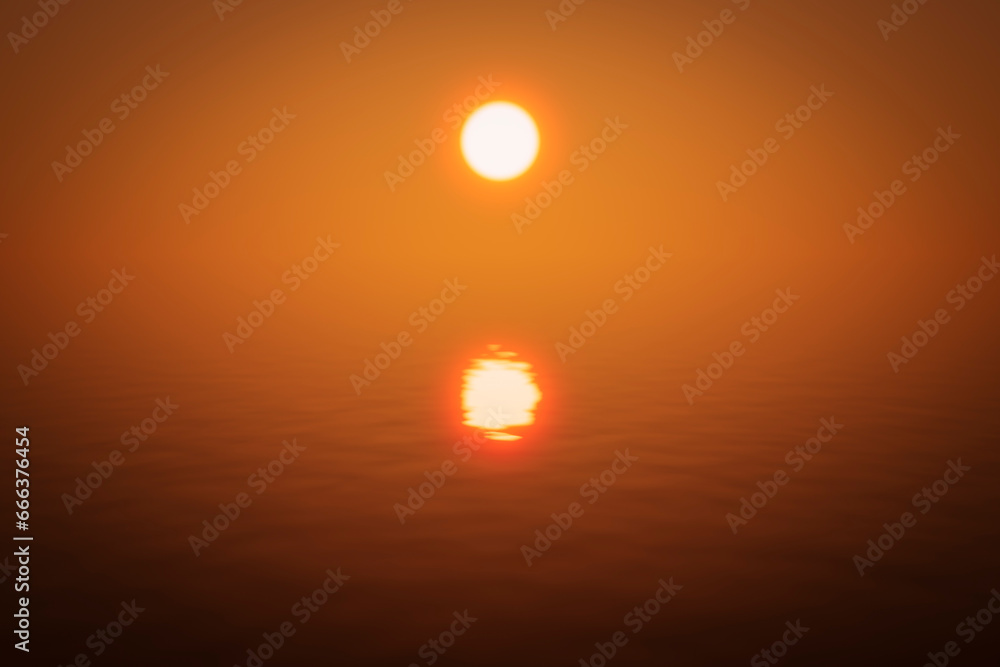 Abstract bright orange sea sunset during fog.