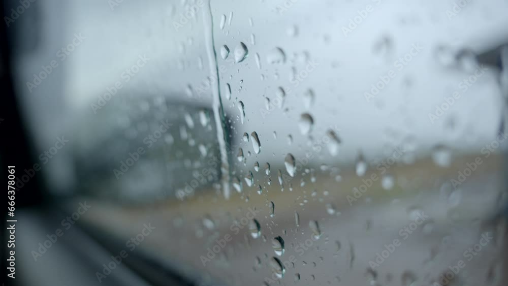 Mirror of car in rainy day drops of water in car glass Mirror of car in rainy day drops of water in car glass