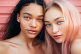 Two women with vibrant pink hair striking pose for photo. This image can be used for fashion, beauty, or diversity-themed projects.
