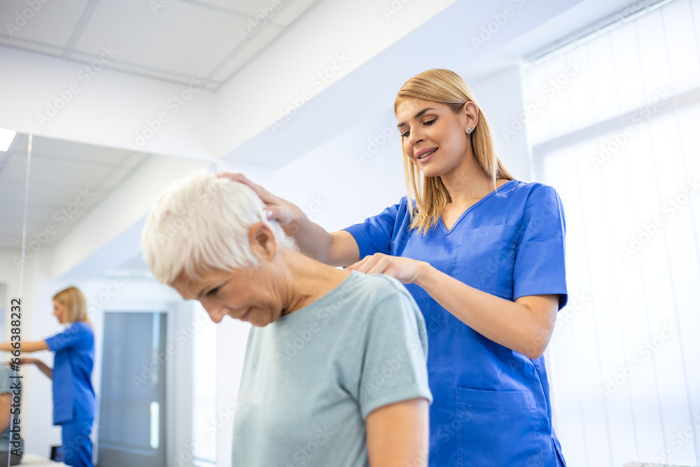 Fototapeta premium Licensed chiropractor or manual therapist doing neck stretch massage to relaxed female patient in clinic office. Young woman with whiplash or rheumatological problem getting professional doctor's help