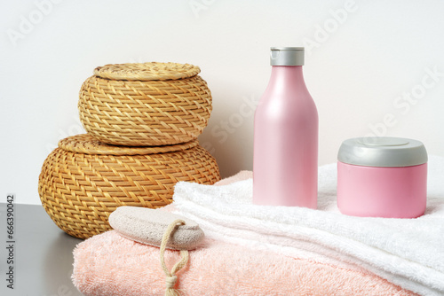 White cosmetics container mockup with towels on gray background