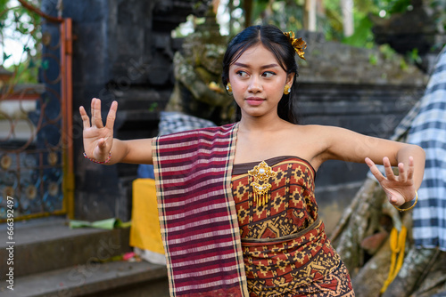 Traditional dancer performing in a temple courtyard in Bali, Indonesia