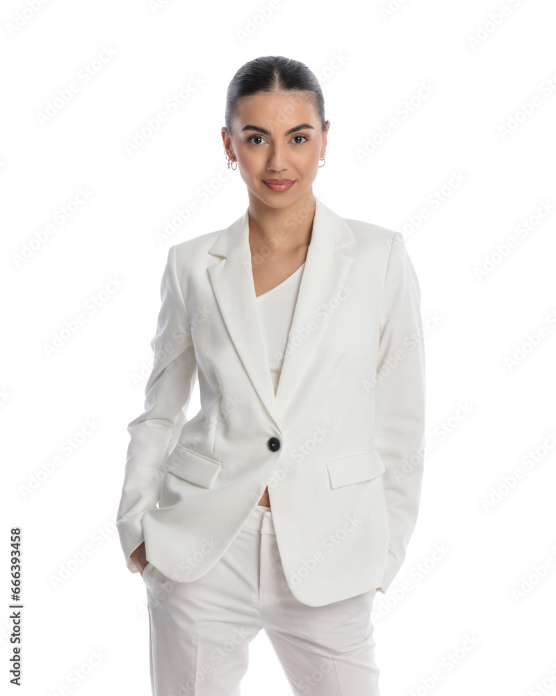 portrait of beautiful young businesswoman in white suit holding hands in pockets portrait of beautiful young businesswoman in white suit holding hands in pockets