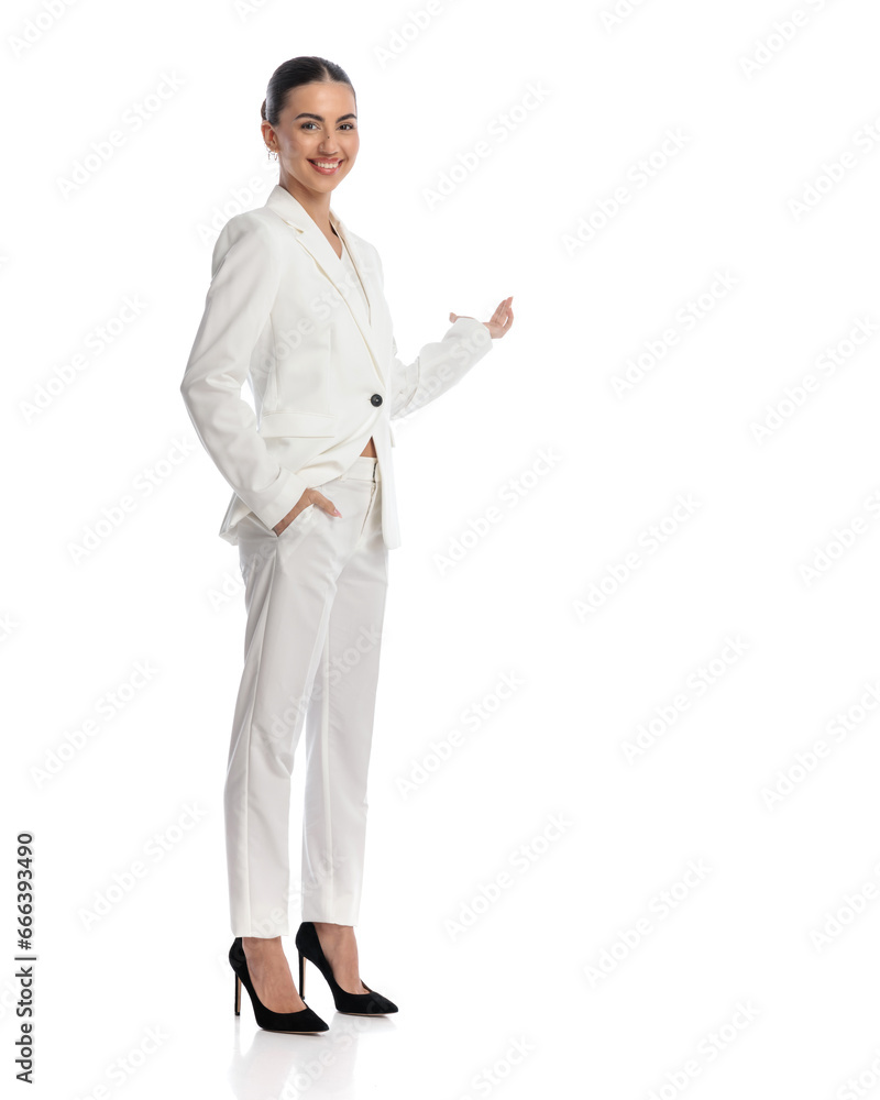 side view of elegant businesswoman in white suit showing to side side view of elegant businesswoman in white suit showing to side