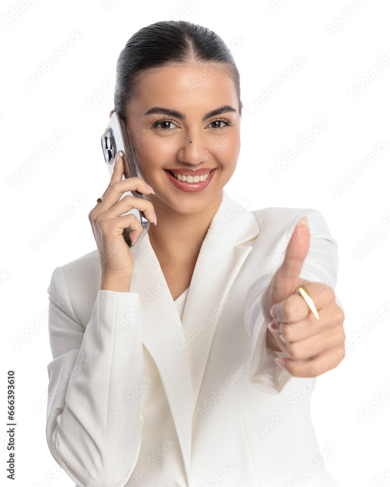 attractive businesswoman talking on the phone and making thumbs up gesture attractive businesswoman talking on the phone and making thumbs up gesture