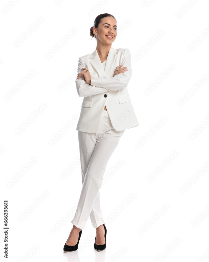 attractive young woman in white suit crossing arms and looking away attractive young woman in white suit crossing arms and looking away