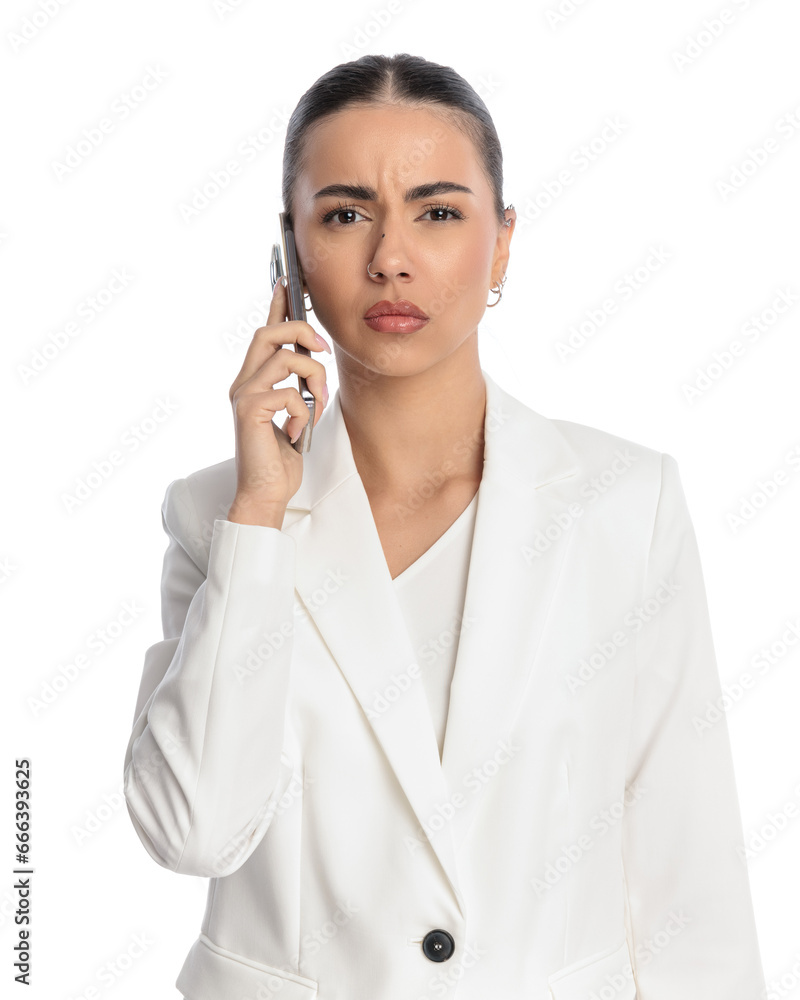 suspicious elegant woman frowning while talking on the phone suspicious elegant woman frowning while talking on the phone