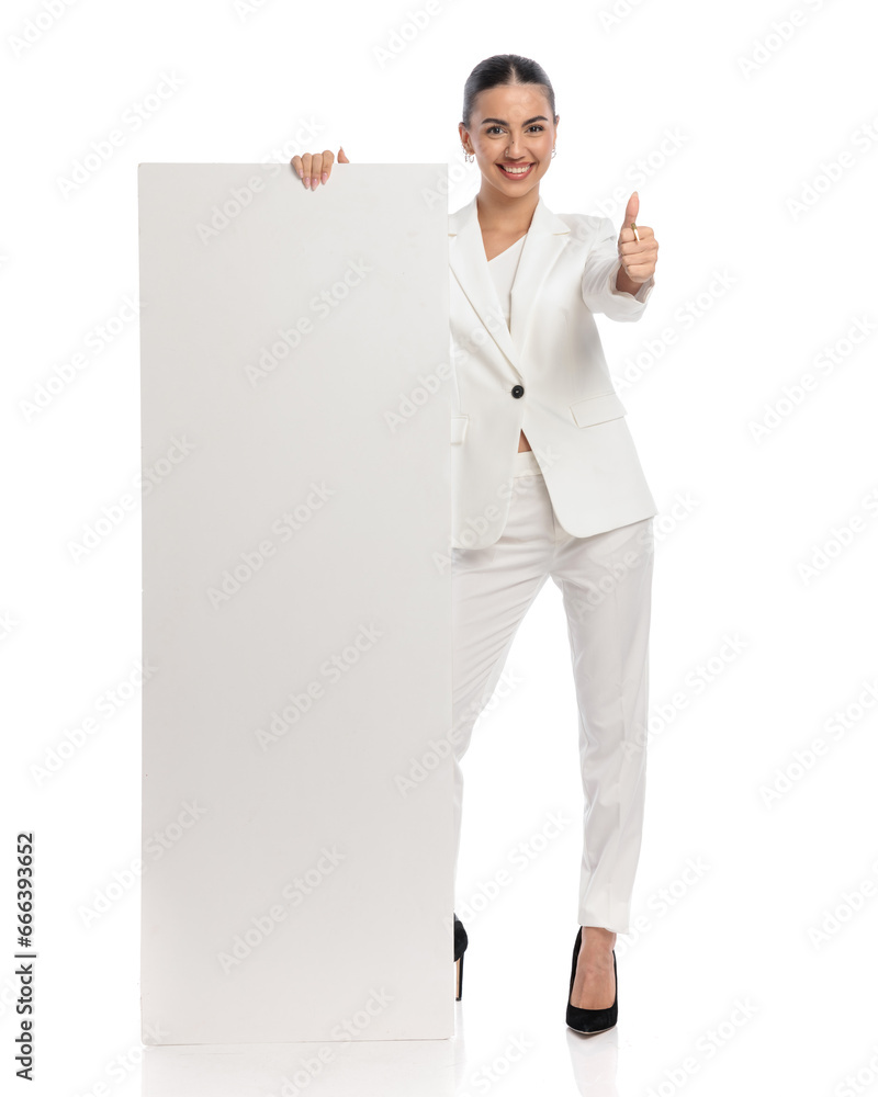 sexy elegant woman in white suit holding board and making thumbs up gesture sexy elegant woman in white suit holding board and making thumbs up gesture