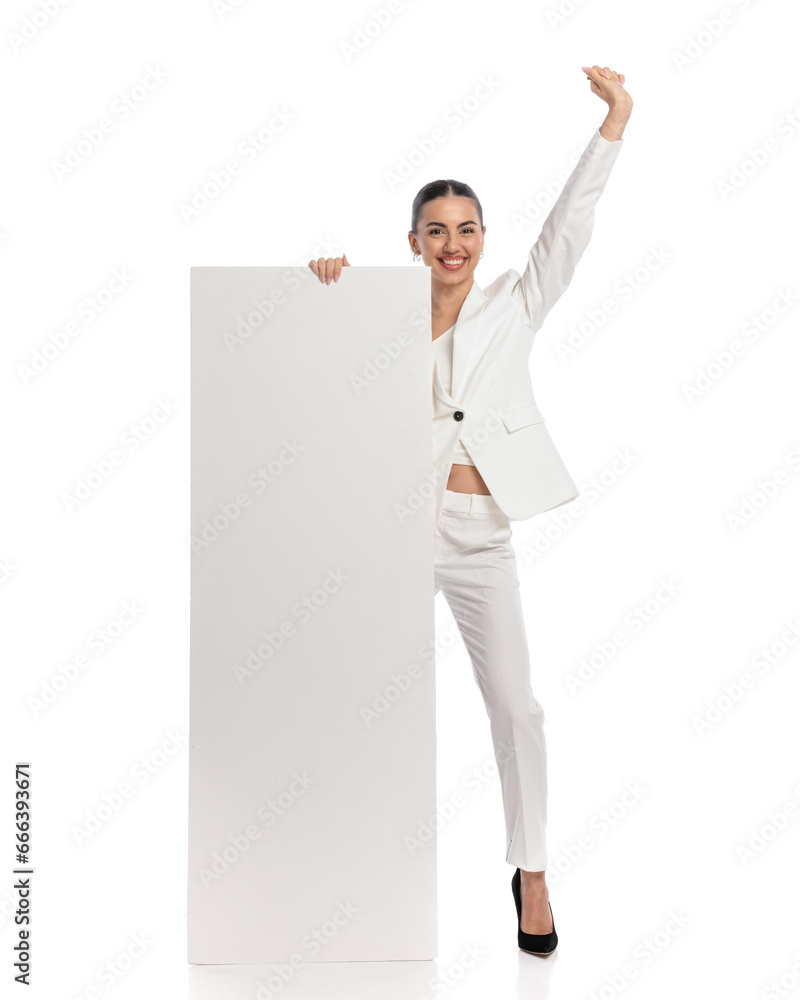 enthusiastic young woman holding and presenting vertical empty board