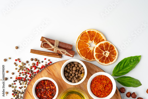 Bowls with spices on wooden board on white background