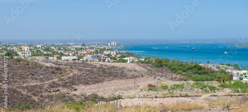 View of the bay, from the hill in the city of La Paz with mountains, city, sea and the mogote. Sunny summer morning, Baja California Sur, MEXICO