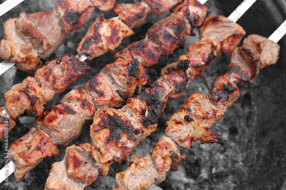 Cooking delicious kebab on metal brazier, above view Cooking delicious kebab on metal brazier, above view