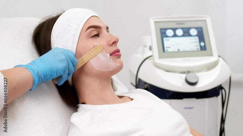 Close-up of a young woman's face during microcurrent therapy. Procedure for electrical stimulation of the face, rejuvenation, anti-wrinkle. The concept of youth and modern cosmetology technologies. Close-up of a young woman's face during microcurrent therapy. Procedure for electrical stimulation of the face, rejuvenation, anti-wrinkle. The concept of youth and modern cosmetology technologies.