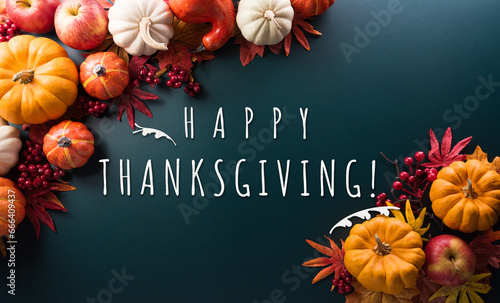 Thanksgiving and Autumn decoration concept made from autumn leaves, pumpkin and the text on dark background.