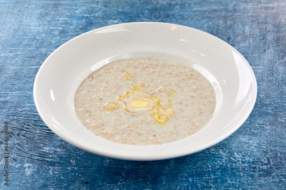 Bowl with tasty oatmeal with butter Bowl with tasty oatmeal with butter