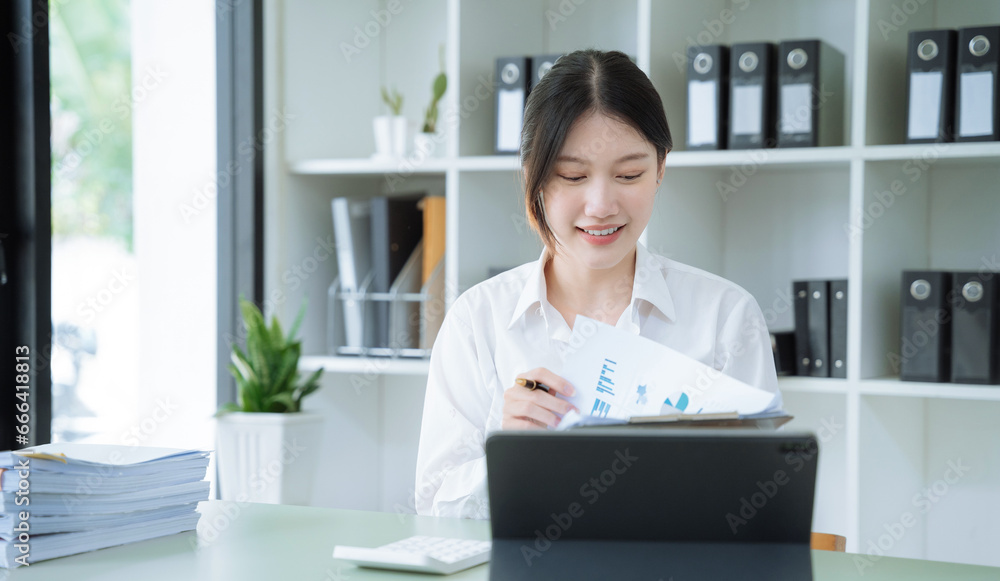 lifestyle of office workers Woman calculating expenses and using laptop. Home office. Work place. Lifestyle. lifestyle of office workers Woman calculating expenses and using laptop. Home office. Work place. Lifestyle.