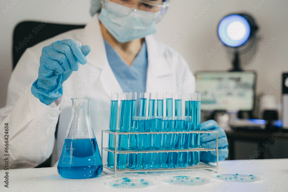 Female scientist researcher conducting an experiment working in the chemical laboratory. Female scientist researcher conducting an experiment working in the chemical laboratory.