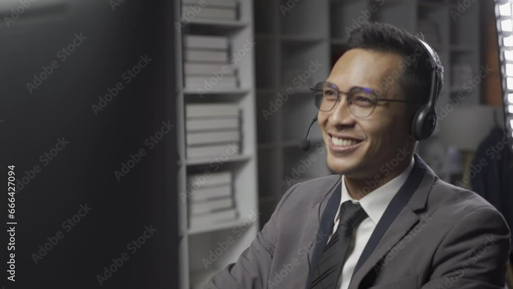Businessman wearing headset sitting in office using desktop computer talking with customers in video conferencing app. Remote help, virtual meeting by business, negotiation concept Businessman wearing headset sitting in office using desktop computer talking with customers in video conferencing app. Remote help, virtual meeting by business, negotiation concept