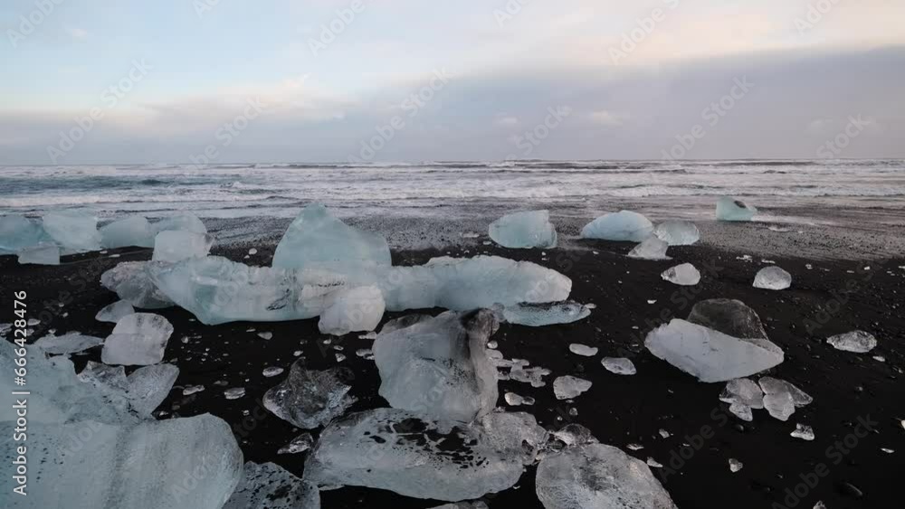 Diamond beach, Iceland. Pieces of icebergs with clear ice. Reflections and light in the ice during sunset. A popular destination for a trip to Iceland. Diamond beach, Iceland. Pieces of icebergs with clear ice. Reflections and light in the ice during sunset. A popular destination for a trip to Iceland.