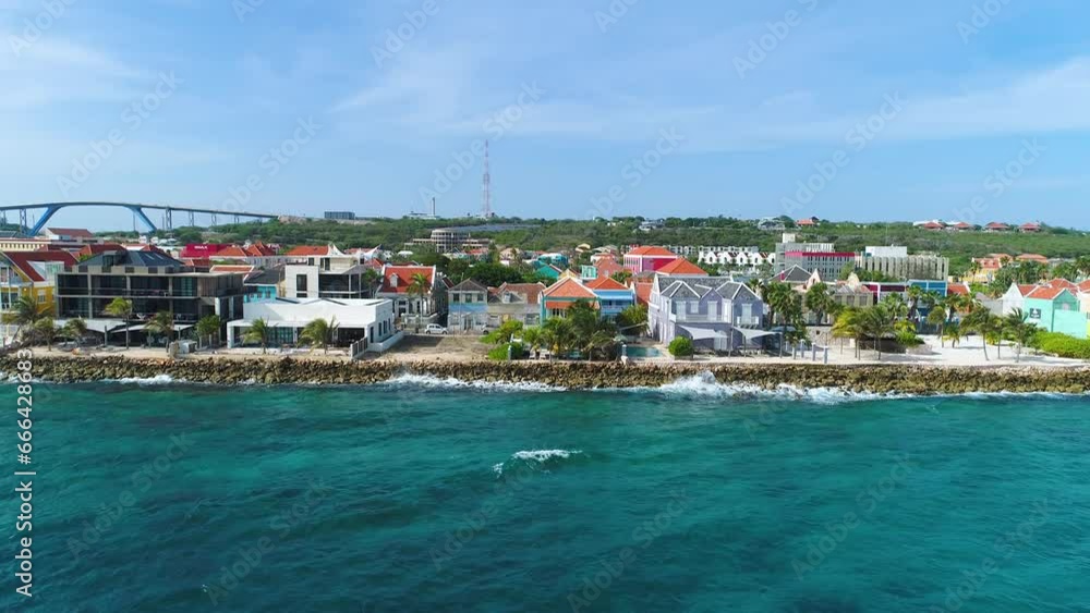 Clear Caribbean waters off coast of Pietermaai and Punda homes on coast, Queen Juliana bridge behind Clear Caribbean waters off coast of Pietermaai and Punda homes on coast, Queen Juliana bridge behind