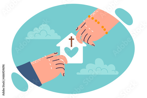 Hands of people with symbol of christian charity in shape of house with heart and catholic cross