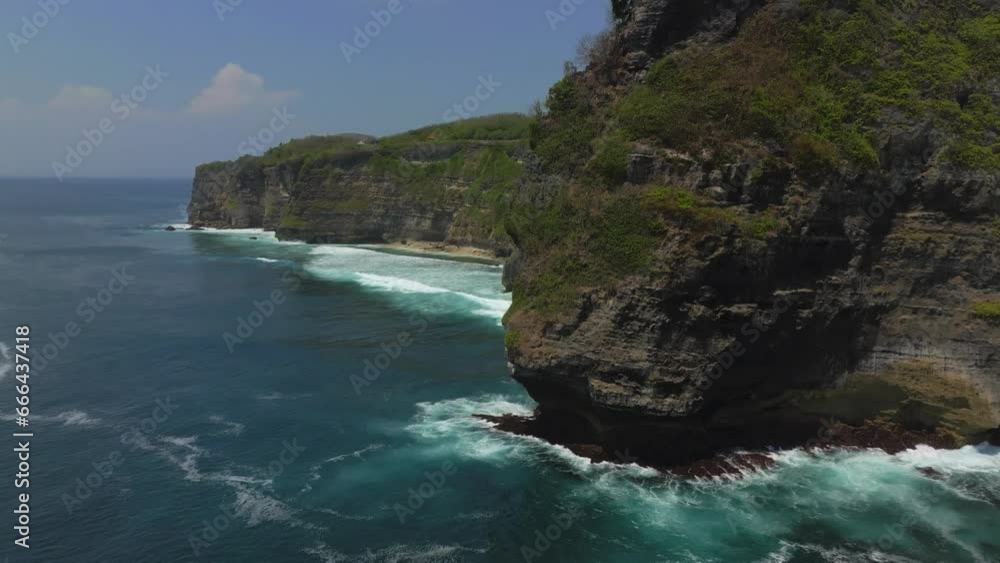 Cliff aerial top down view of a rocky coastline in Uluwatu, Bali. Cliff aerial top down view of a rocky coastline in Uluwatu, Bali.