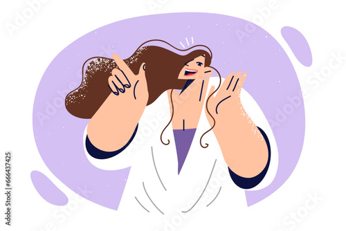 Happy woman joyfully raises hand to mouth, tell urgent news and points finger in side