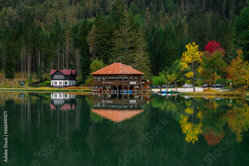 Toblach, Italy - 3 October 2021: View of house and restaurant on the lake, Dolomites, Italy. photo