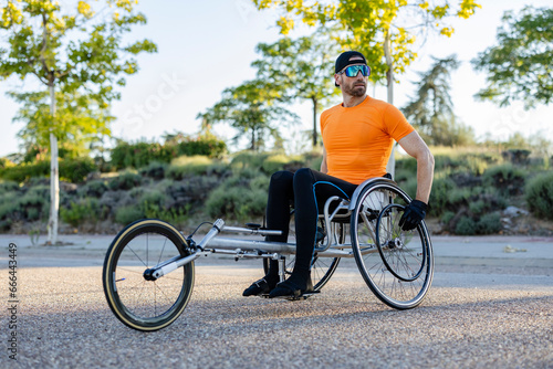 Mature sportsman with physical disabilities taking part in race competition photo