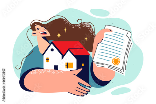 Woman become owner of house, holds certificate of ownership and miniature model of cottage