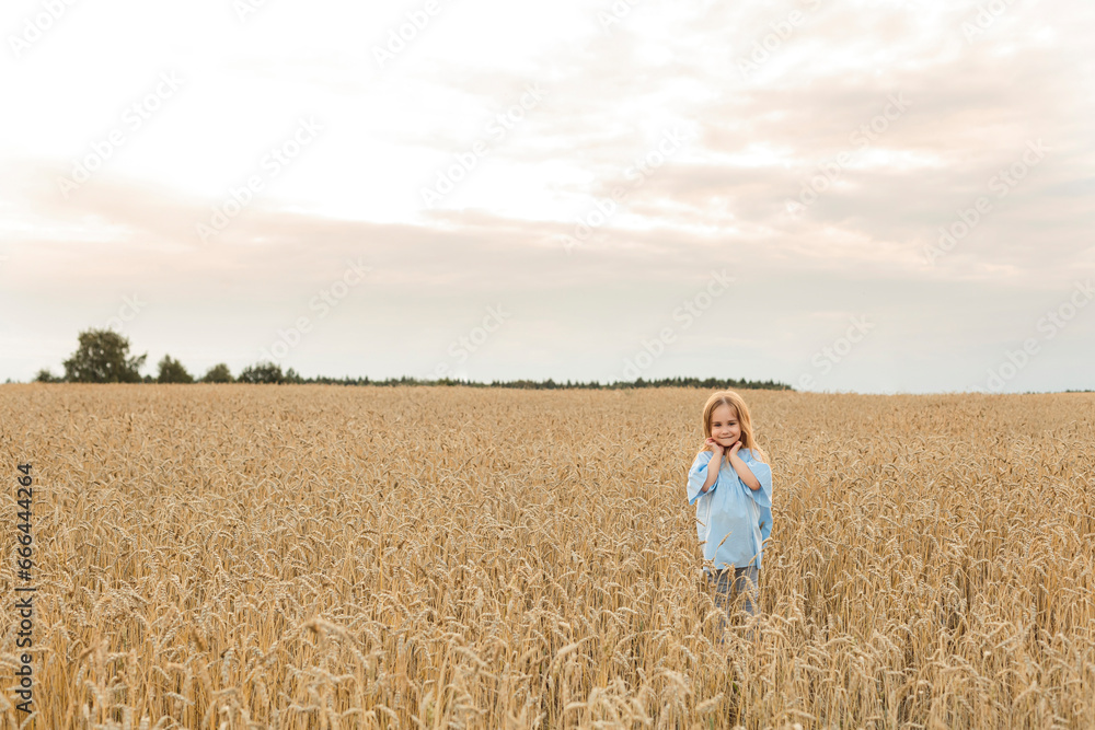 Smiling girl standing amidst field under sky Smiling girl standing amidst field under sky