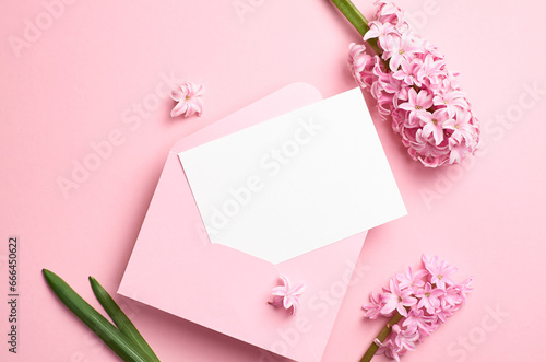 Blank greeting or invitation card mockup with envelope and flowers, white card mock up with copy space © nikavera