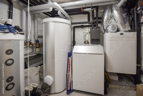 the interior of a modern boiler room - technical room with equipment of an family house with minergie a low energy house label with renewable energy