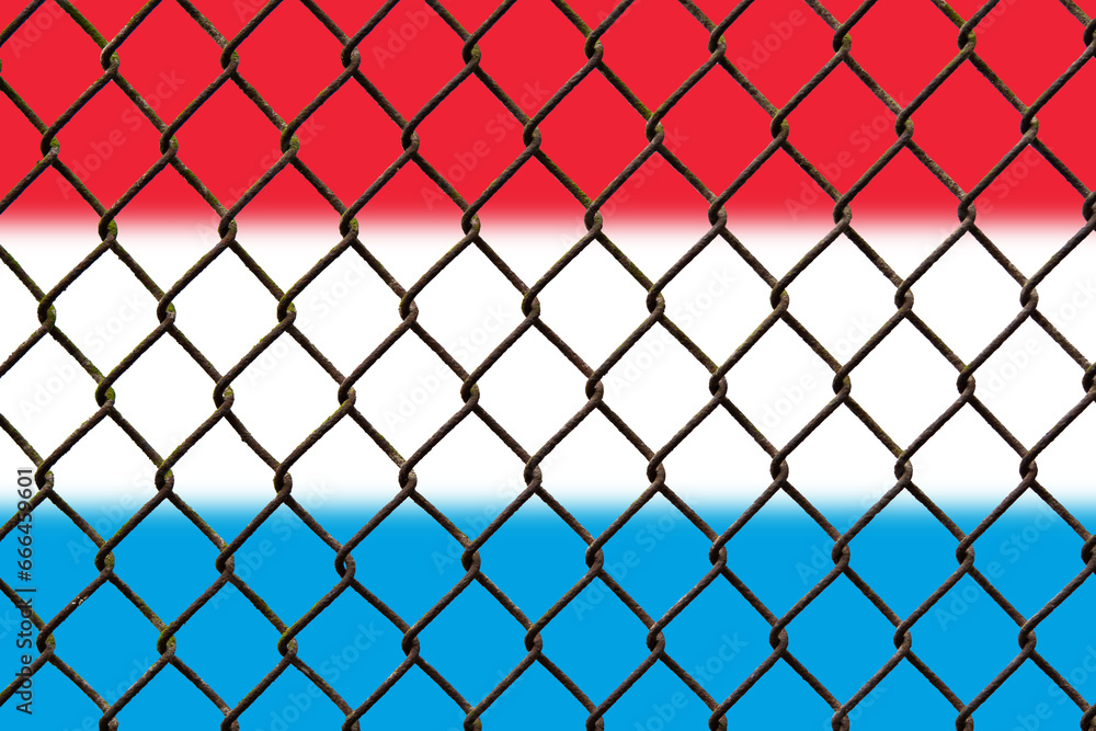 Fototapeta premium A steel mesh against the background of the flag Luxembourg.