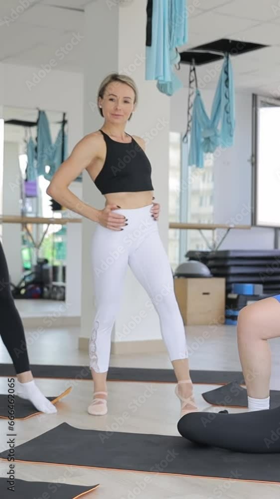A group of beautiful women in the gym, they are smiling and looking at the camera. Vertical video. A group of beautiful women in the gym, they are smiling and looking at the camera. Vertical video.