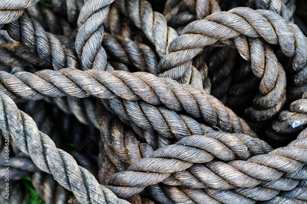Antique rope made from natural materials. Fragment of a braided cord of large diameter. Close-up Antique rope made from natural materials. Fragment of a braided cord of large diameter. Close-up