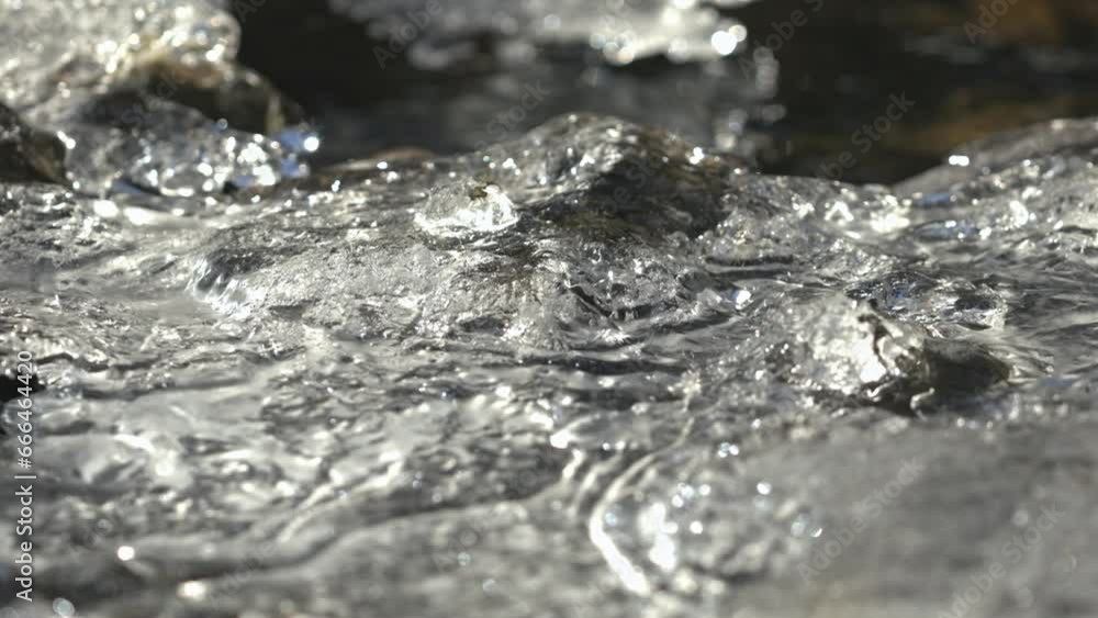 Portraying the surface of an alien planet, ice has formed over part of creek Portraying the surface of an alien planet, ice has formed over part of creek
