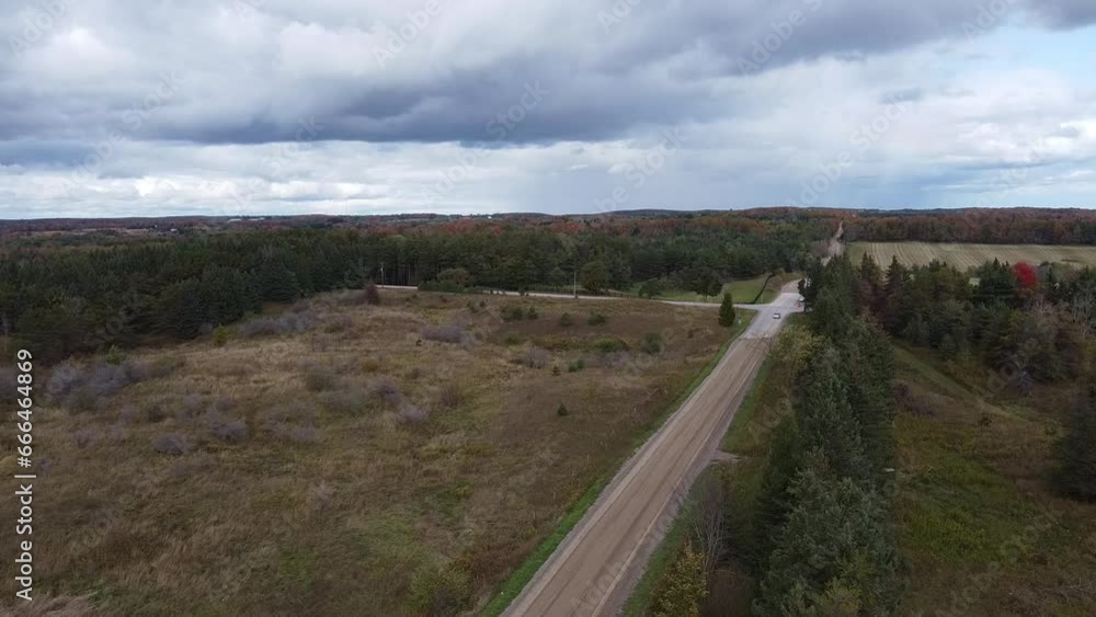 Car Drives Along A Side Road In Rural Caledon, Aerial Shot