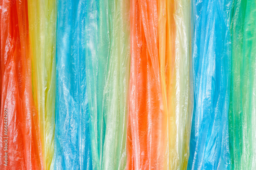 colorful strip of plastic bags in red , yellow, blue, green color ,background and environment concept colorful strip of plastic bags in red , yellow, blue, green color ,background and environment concept