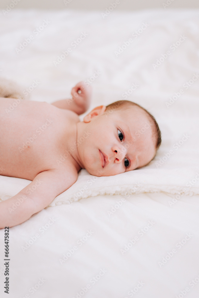 newborn in studio lighting against white newborn in studio lighting against white