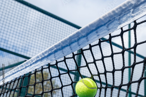 ball hitting the net of a paddle tennis court © VicVaz