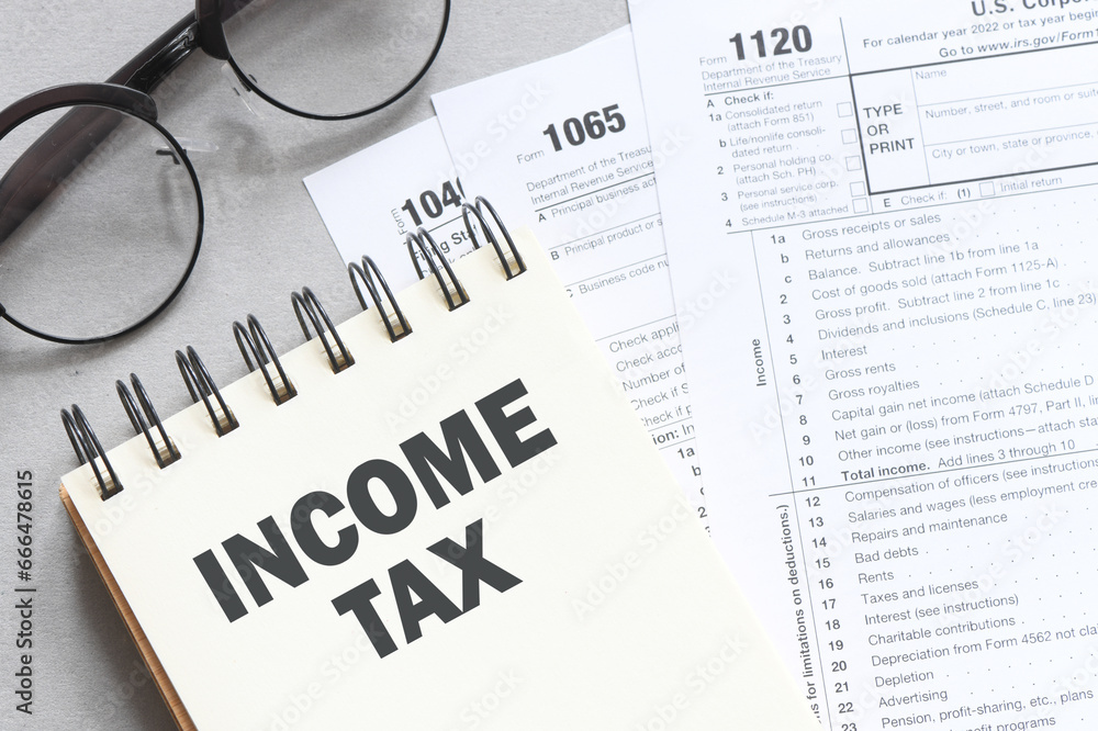 INCOME TAX words in an office notebook. Concept for business. INCOME TAX words in an office notebook. Concept for business.