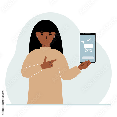 A woman holds a mobile phone in his hand with an application for online shopping. The phone has a shopping cart.