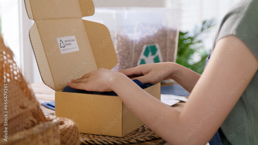 Eco vendor go green packaging parcel carton box in net zero waste store asian seller retail shop. Earth care day small SME owner asia people wrap reuse brown paper pack gift reduce plastic free order. - obrazy, fototapety, plakaty 